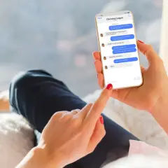 Dłoń trzyma smartfon z rozmową na Messengerze. Można tu zobaczyć, jak być niewidocznym na Messengerze, ale widzieć innych, gdy ekran pokazuje status "online" u rozmówcy.
